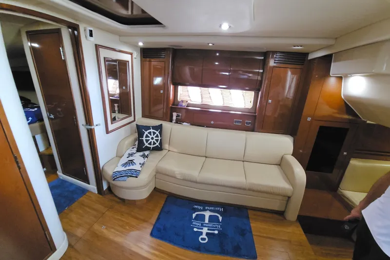 Slide: The Image of Luxurious 2008 Sea Ray 40 Sundancer interior with cream sofa and nautical decor. - 27