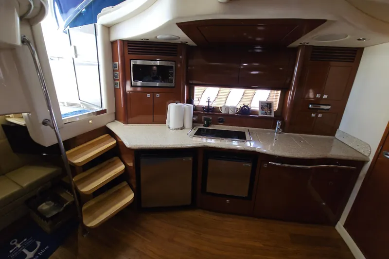 Slide: The Image of Luxurious kitchen interior of 2008 Sea Ray 40 Sundancer yacht with modern amenities. - 29