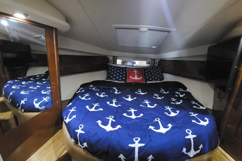 Slide: The Image of Luxurious cabin interior of 2008 Sea Ray 40 Sundancer with nautical-themed bedding. - 30