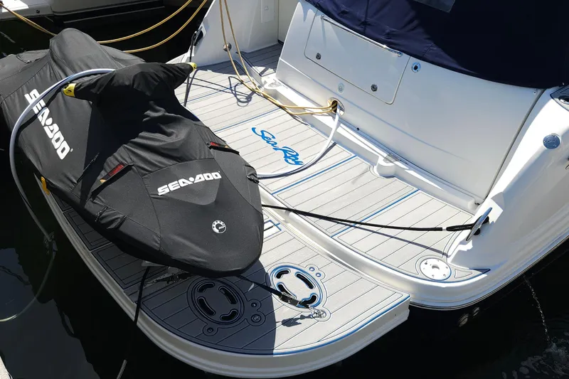 Slide: The Image of 2008 Sea Ray 40 Sundancer with Sea-Doo on swim platform, docked. - 9