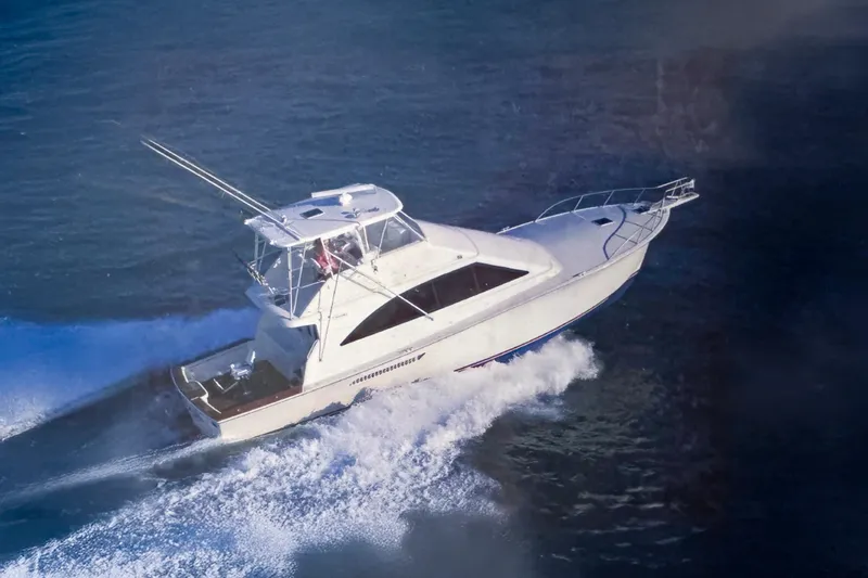 The Image of 2002 Ocean Yachts 56 Super Sport cruising on open water, aerial view. - 1