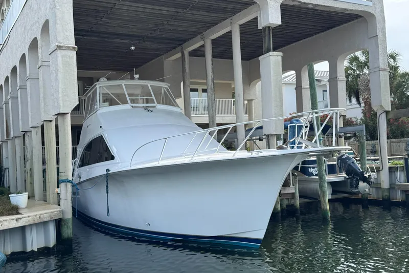 Slide: The Image of 2002 Ocean Yachts 56 Super Sport docked under a covered marina. - 3