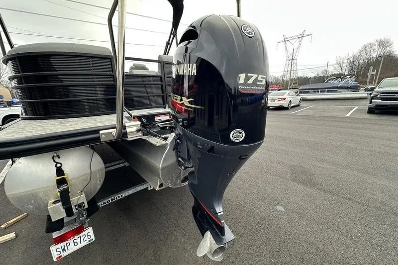 Slide: The Image of 2021 Bennington 22 pontoon boat with Yamaha 175 outboard motor in parking lot. - 11