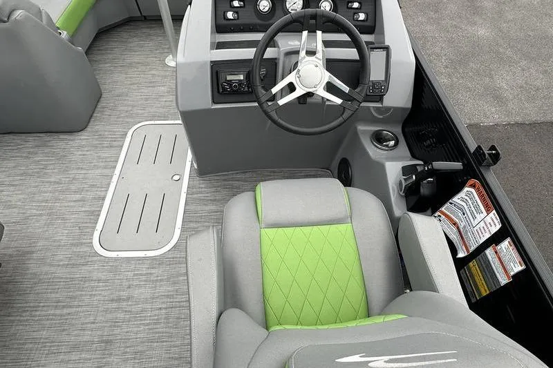 Slide: The Image of 2021 Bennington 22 boat interior with gray and green seating, steering wheel, and control panel. - 17