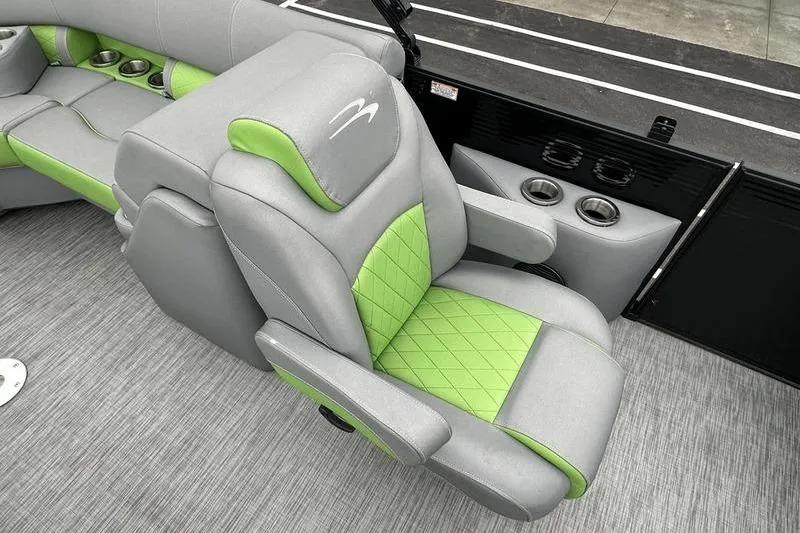 Slide: The Image of 2021 Bennington 22 boat interior with gray and green seating, cup holders, and modern design. - 23