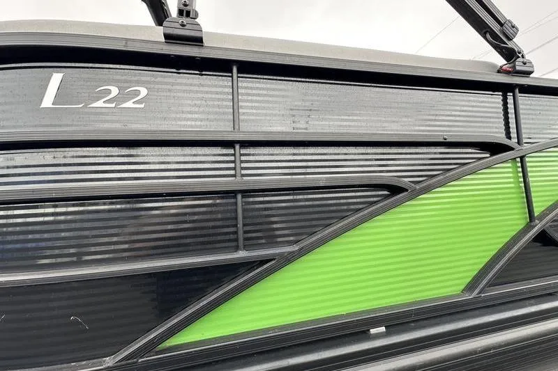 Slide: The Image of 2021 Bennington L22 boat with sleek black and green design details. - 25