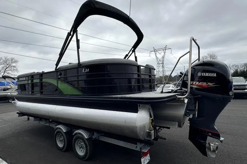 Slide: The Image of 2021 Bennington 22 pontoon boat on trailer with Yamaha outboard motor. - 26