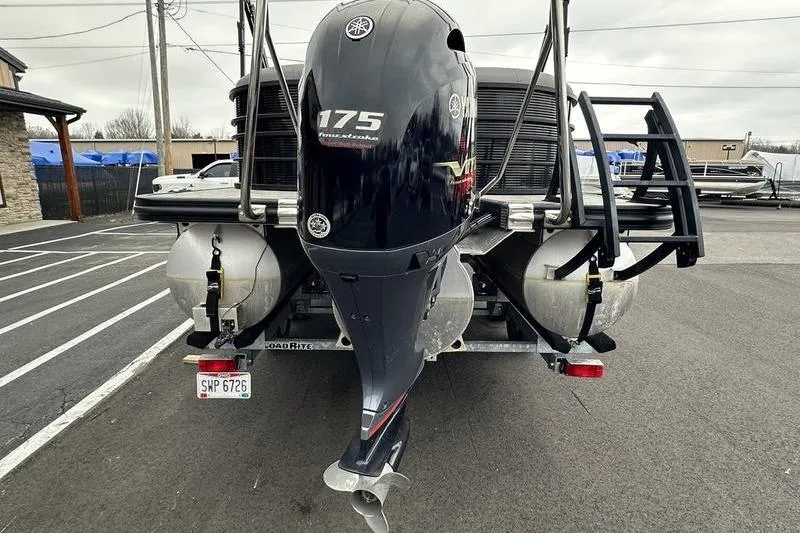 Slide: The Image of 2021 Bennington 22 boat with Yamaha 175 outboard motor, parked on a trailer. - 3