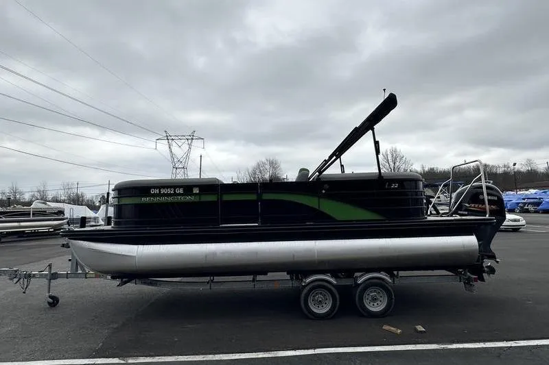 Slide: The Image of 2021 Bennington 22 pontoon boat on trailer under cloudy sky. - 4