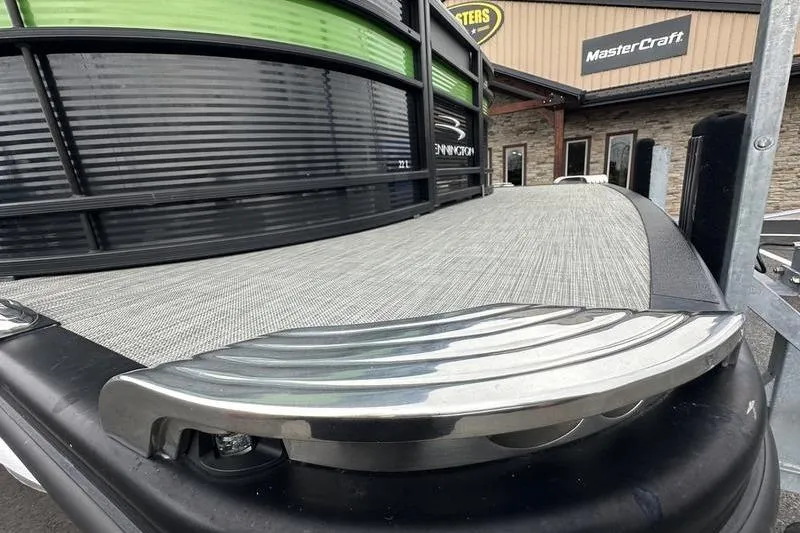 Slide: The Image of 2021 Bennington 22 boat with sleek design, displayed at MasterCraft dealership. - 5