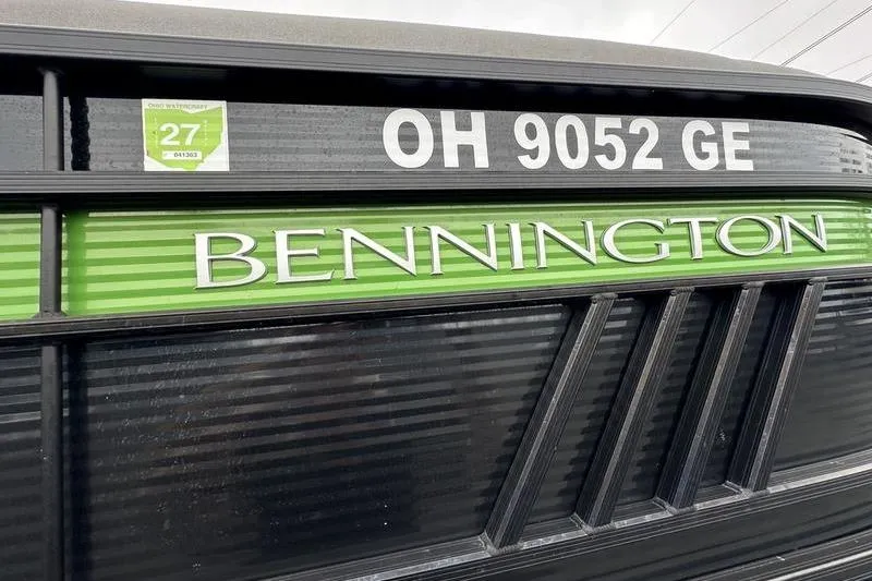 Slide: The Image of 2021 Bennington 22 boat with registration OH 9052 GE, green and black design. - 6