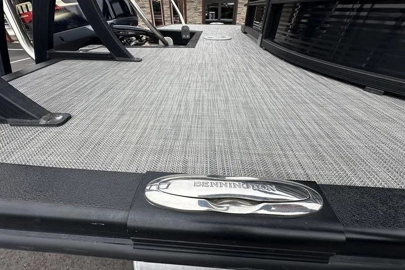 Slide: The Image of 2021 Bennington 22 boat deck with sleek design and metallic logo detail. - 8