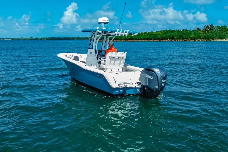 Slide: The Image of 2026 Tidewater 232 LXF boat on clear blue water with Yamaha engine. - 11