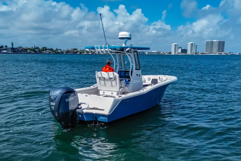 Slide: The Image of 2026 Tidewater 232 LXF boat on water, Yamaha engine, city skyline in background. - 13