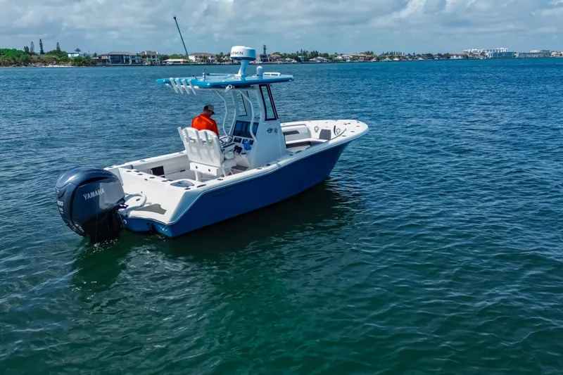 Slide: The Image of 2026 Tidewater 232 LXF boat on calm blue water with Yamaha engine. - 14