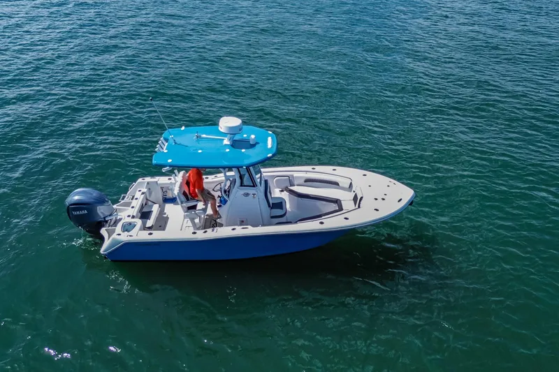 Slide: The Image of 2026 Tidewater 232 LXF boat on open water, featuring a blue canopy and Yamaha engine. - 16
