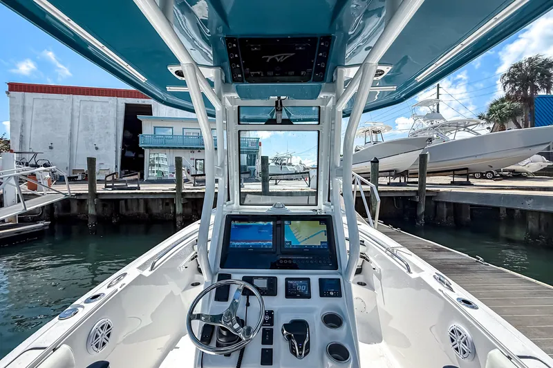 Slide: The Image of 2026 Tidewater 232 LXF boat interior with advanced navigation system at marina. - 23