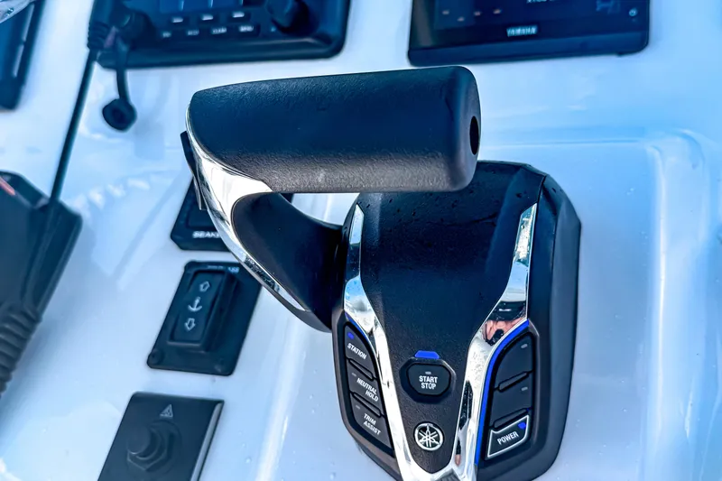 Slide: The Image of Close-up of 2026 Tidewater 232 LXF boat throttle control on dashboard. - 27