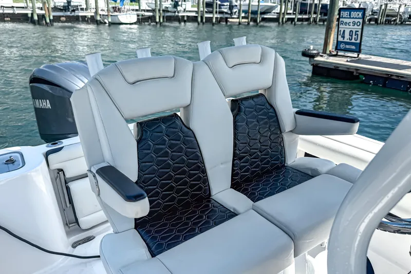 Slide: The Image of 2026 Tidewater 232 LXF boat seats with stylish design, docked near fuel station. - 29