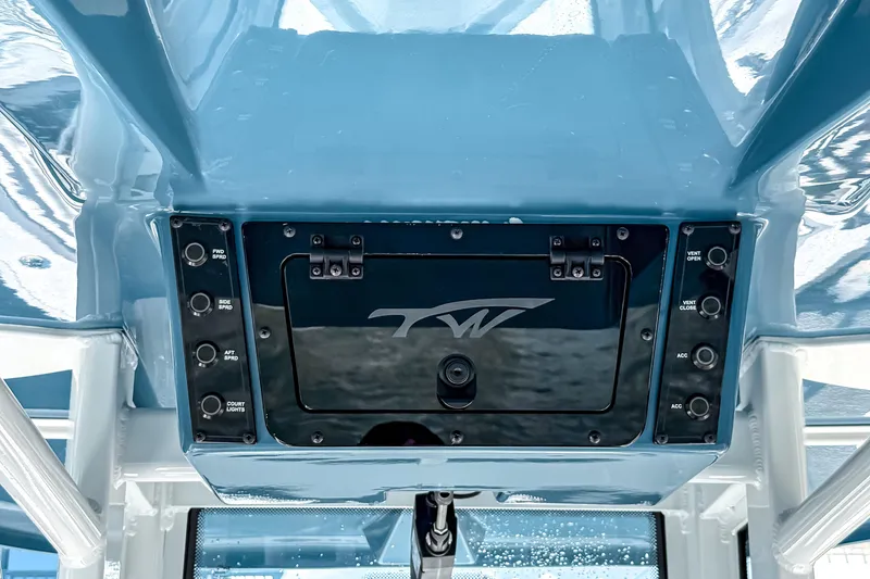 Slide: The Image of 2026 Tidewater 232 LXF boat console with control panel and storage compartment. - 30