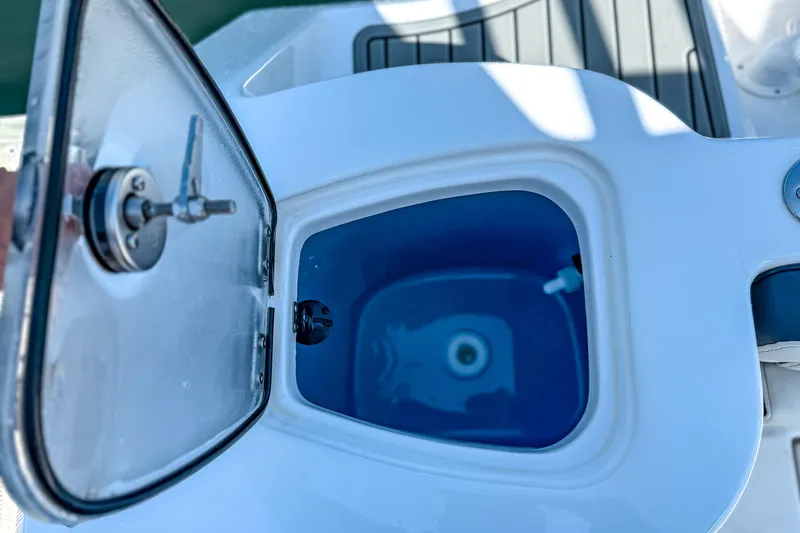 Slide: The Image of Open hatch on 2026 Tidewater 232 LXF boat, revealing interior compartment. - 37