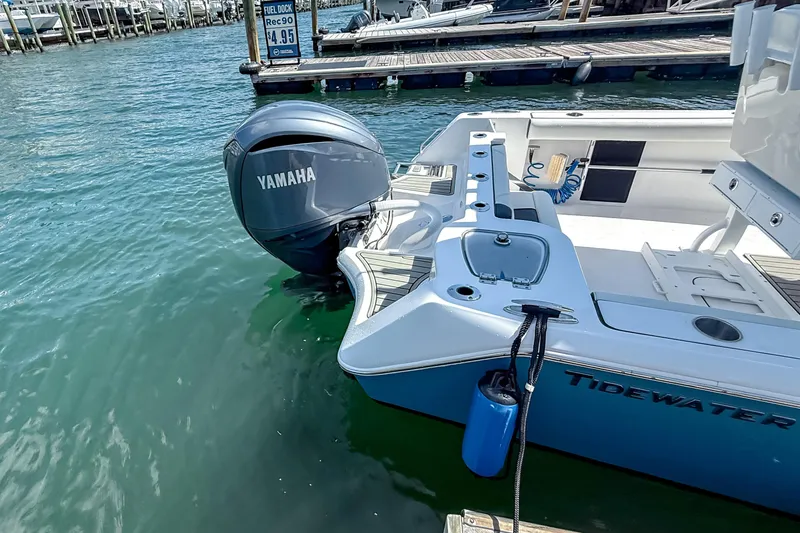 Slide: The Image of 2026 Tidewater 232 LXF boat with Yamaha engine docked at marina. - 4