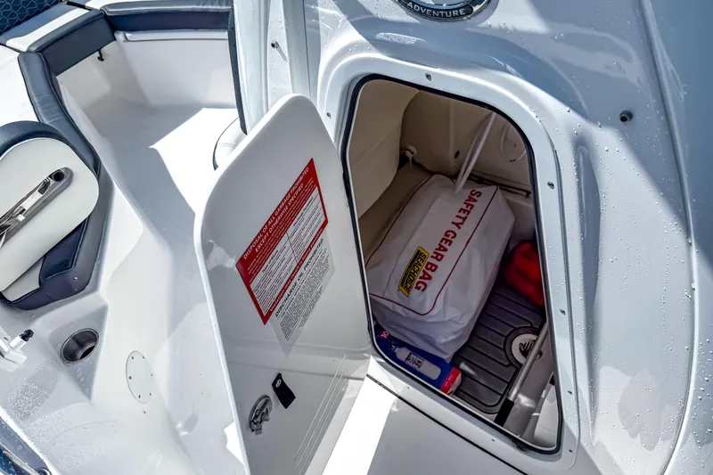 Slide: The Image of 2026 Tidewater 232 LXF boat storage compartment with safety gear bag. - 40