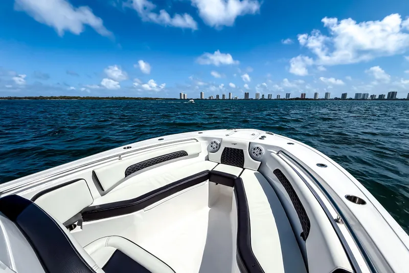 Slide: The Image of 2026 Tidewater 232 LXF boat on open water with city skyline in background. - 43