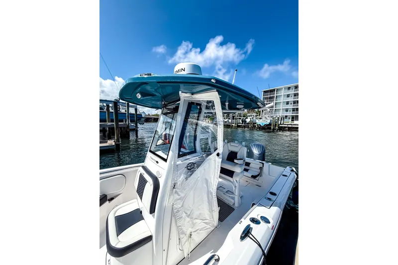 Slide: The Image of 2026 Tidewater 232 LXF boat docked, featuring sleek design and modern amenities. - 46