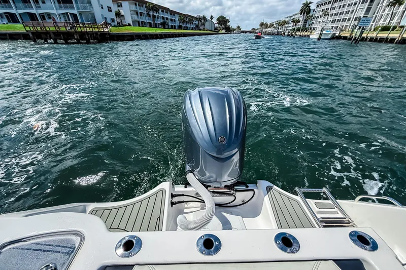 Slide: The Image of 2026 Tidewater 232 LXF boat on waterway, featuring powerful outboard motor. - 5