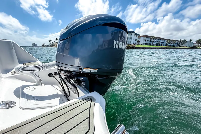 Slide: The Image of 2026 Tidewater 232 LXF boat with Yamaha engine on water, scenic coastal backdrop. - 6