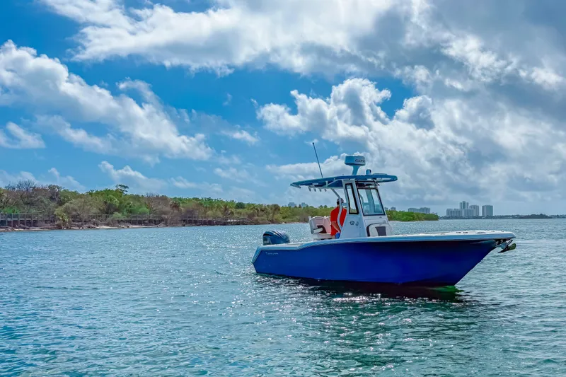 Slide: The Image of 2026 Tidewater 232 LXF boat on calm water under a partly cloudy sky. - 8