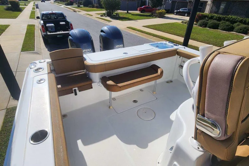 Slide: The Image of 2020 Sea Hunt Gamefish 27 boat with forward seating, parked on a residential street. - 11