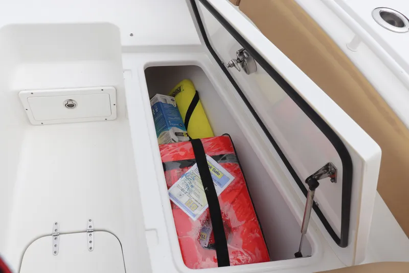 Slide: The Image of Storage compartment on 2020 Sea Hunt Gamefish 27 boat with safety gear and supplies. - 12