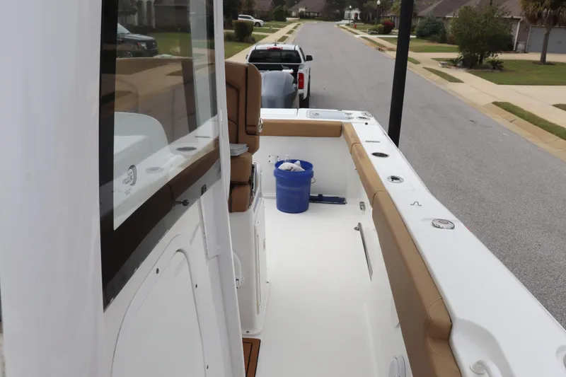 Slide: The Image of 2020 Sea Hunt Gamefish 27 boat with forward seating, parked on a residential street. - 14