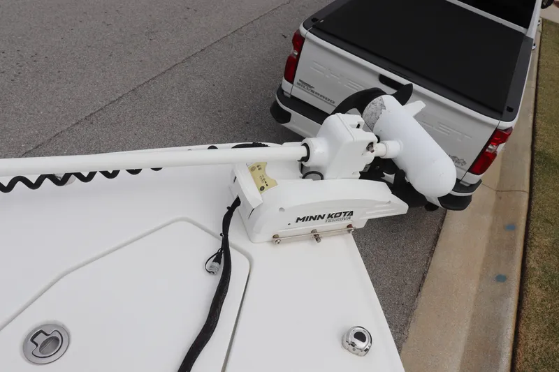 Slide: The Image of 2020 Sea Hunt Gamefish 27 with Minn Kota motor near a parked truck. - 16