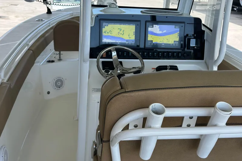 Slide: The Image of 2020 Sea Hunt Gamefish 27 helm with dual navigation screens and brown seating. - 21