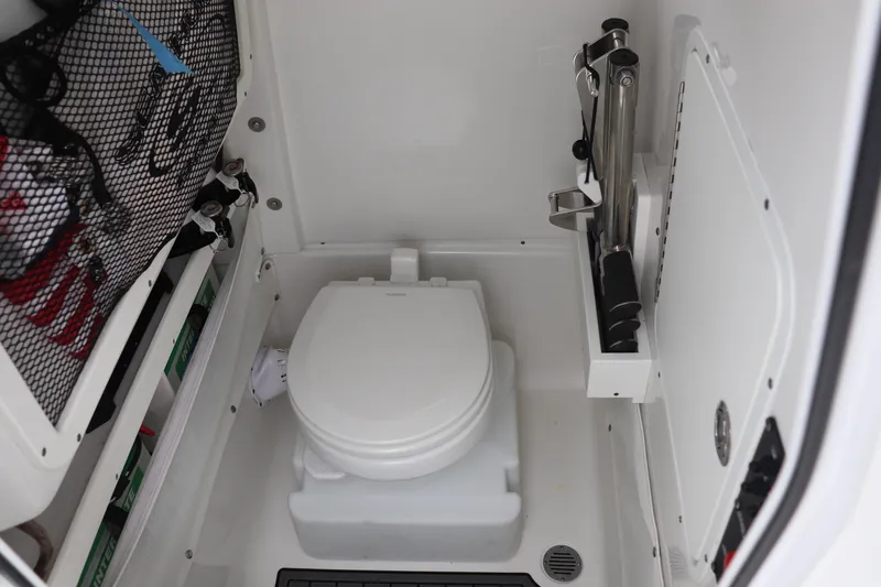 Slide: The Image of 2020 Sea Hunt Gamefish 27 boat interior with compact marine toilet and storage. - 5