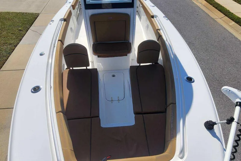Slide: The Image of 2020 Sea Hunt Gamefish 27 Forward Seating boat with brown cushioned seats and white deck. - 8