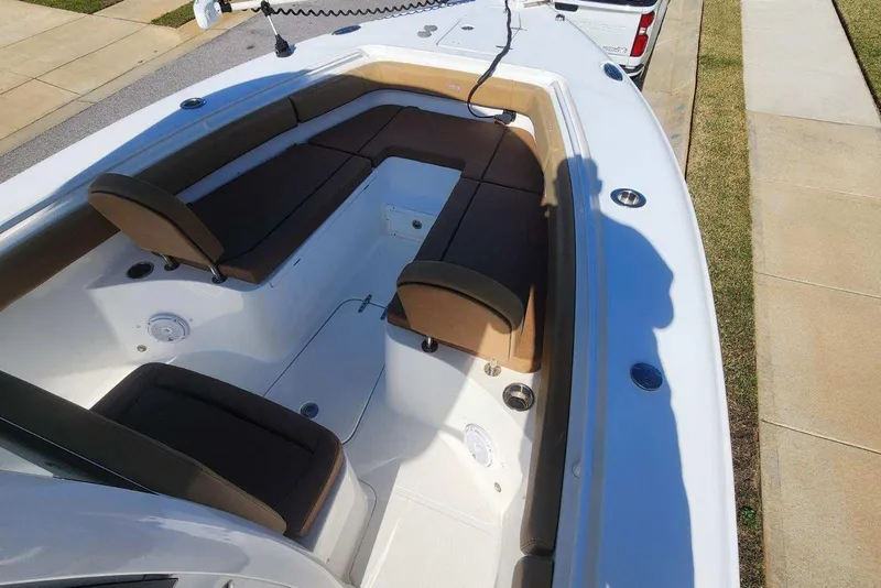 Slide: The Image of 2020 Sea Hunt Gamefish 27 Forward Seating with brown cushions and spacious layout. - 9
