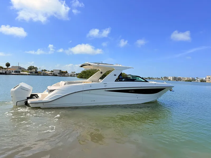 Slide: The Image of 2026 Sea Ray SLX 400 Outboard on calm water under clear sky. - 0