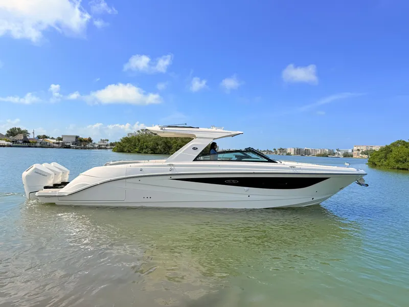 Slide: The Image of 2026 Sea Ray SLX 400 Outboard on calm water under clear sky. - 1