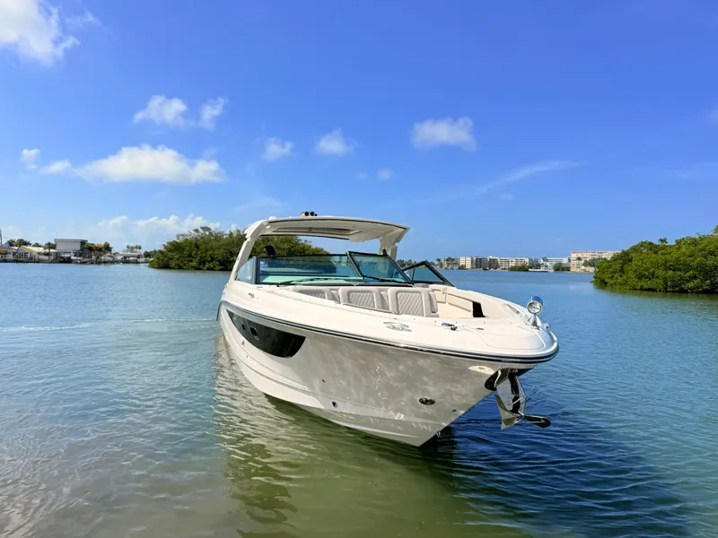 Slide: The Image of 2026 Sea Ray SLX 400 Outboard on calm water under clear sky. - 18