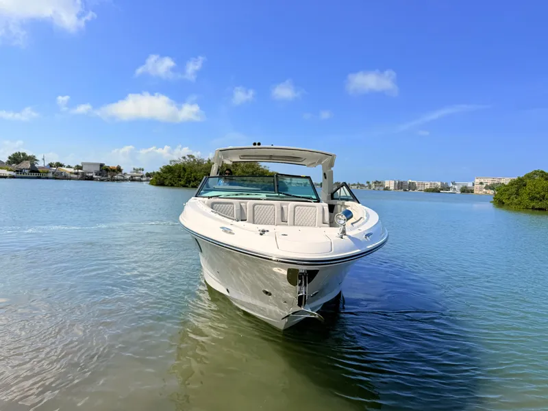 Slide: The Image of 2026 Sea Ray SLX 400 Outboard on calm water under clear sky. - 19
