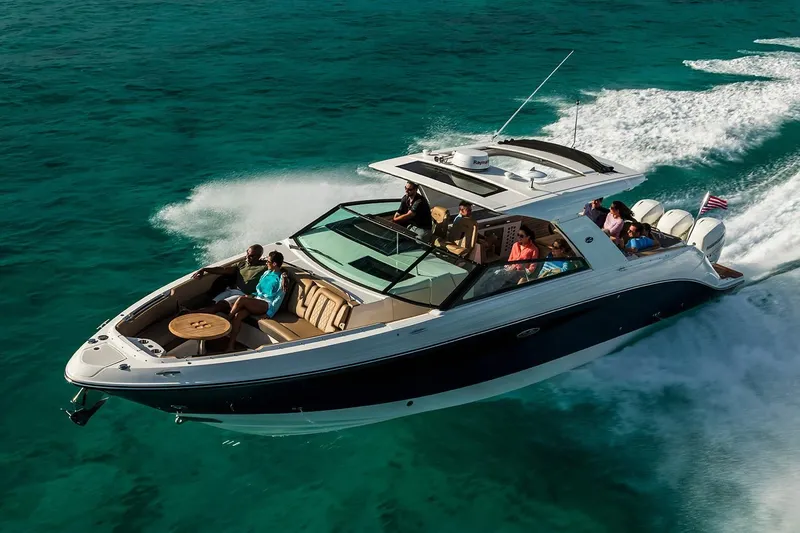 Slide: The Image of 2026 Sea Ray SLX 400 Outboard on calm water under clear sky. - 2