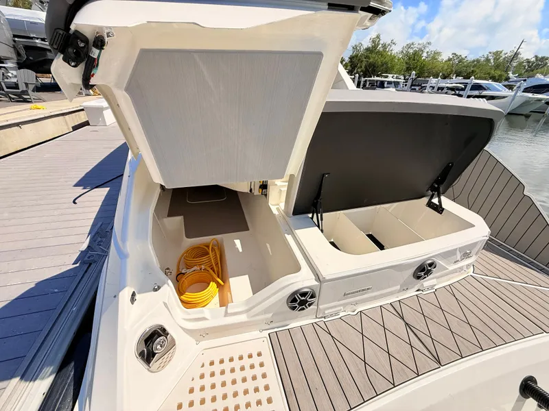 Slide: The Image of Storage area of 2026 Sea Ray SLX 400 Outboard with yellow cable. - 29