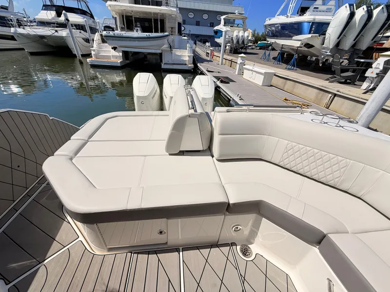 Slide: The Image of 2026 Sea Ray SLX 400 Outboard with luxurious seating area at the marina. - 37