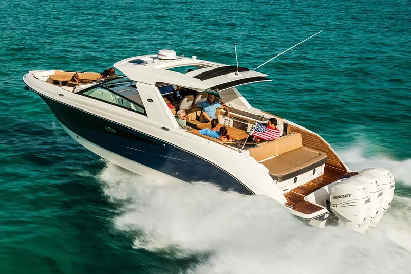 Slide: The Image of 2026 Sea Ray SLX 400 Outboard on calm water under clear sky. - 4