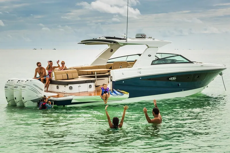 Slide: The Image of 2026 Sea Ray SLX 400 Outboard on calm water under clear sky. - 5