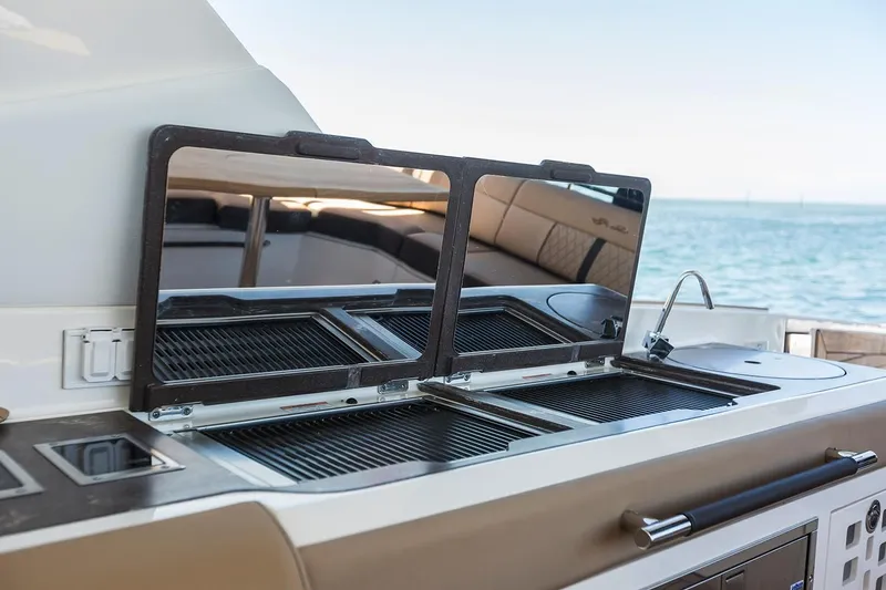 Slide: The Image of 2026 Sea Ray SLX 400 Outboard on calm water under clear sky. - 9
